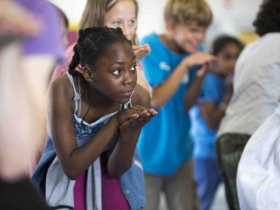 Young dancer learning moves from Swan Lake