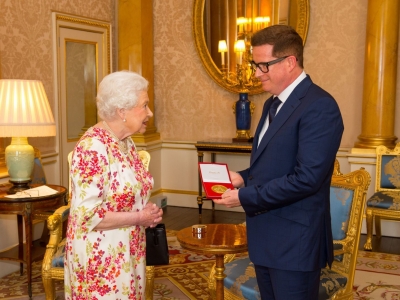 Matthew receiving the Queen Elizabeth II Coronation (QEII) Award from Her Majesty The Queen